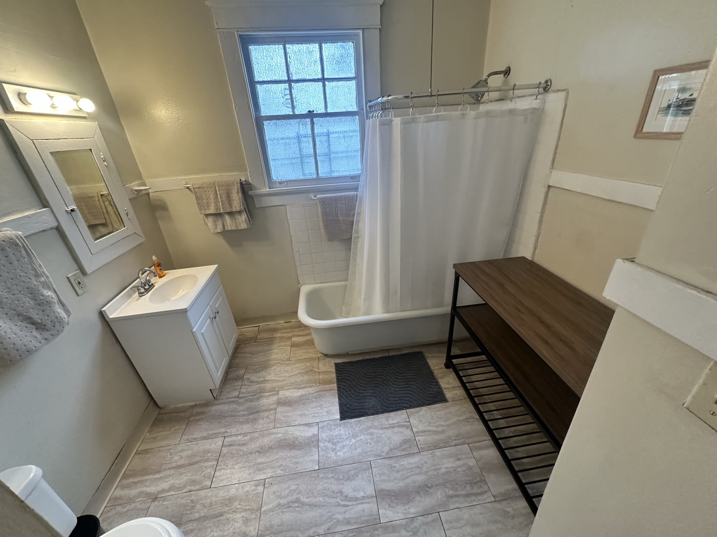 A clean bathroom at a Magnolia Haven Recovery home with a tub and shower